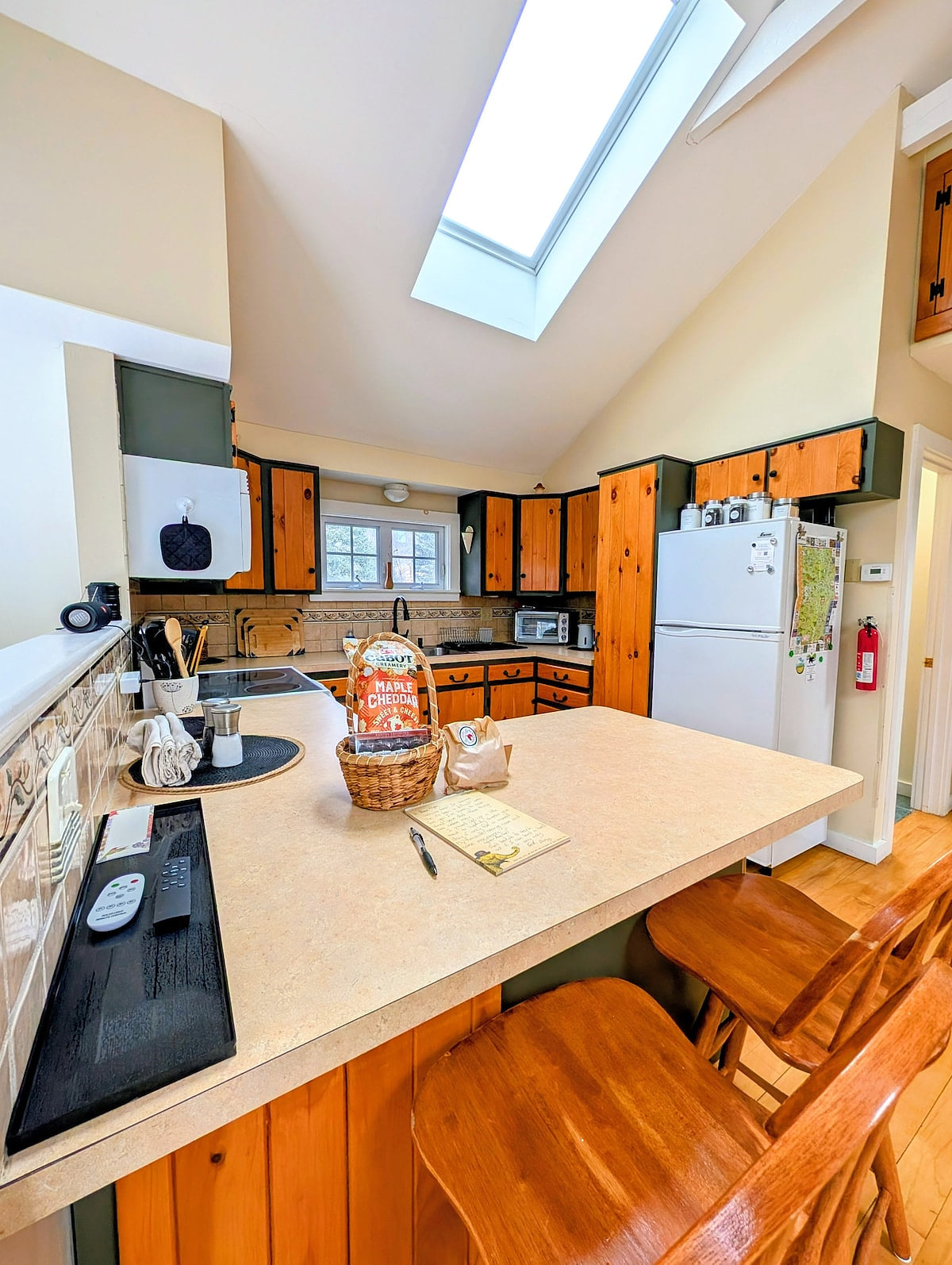 Fully equipped kitchen with breakfast bar, skylight, and everything needed for easy meals in