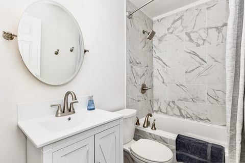 Full bath with shower and tub combo.