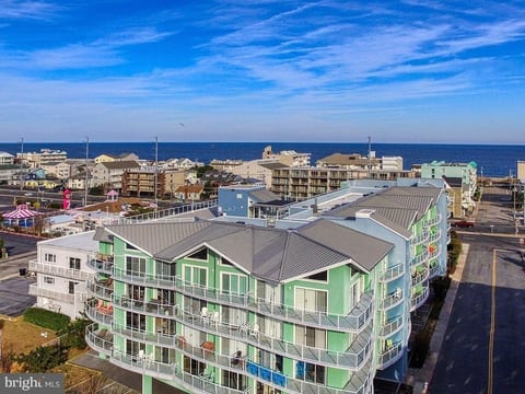 Arial view showing the west and south sides of the condo building and the building's proximity to the Atlantic Ocean and its beautiful beach.