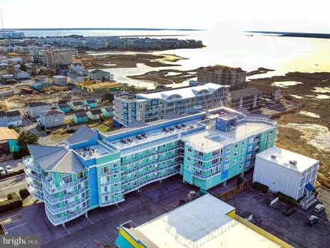 Arial view showing the north side of the condo building, the pool and the building's proximity to the Assawoman Bay.
