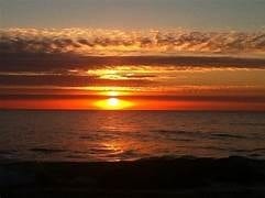 Sun setting on the ocean.