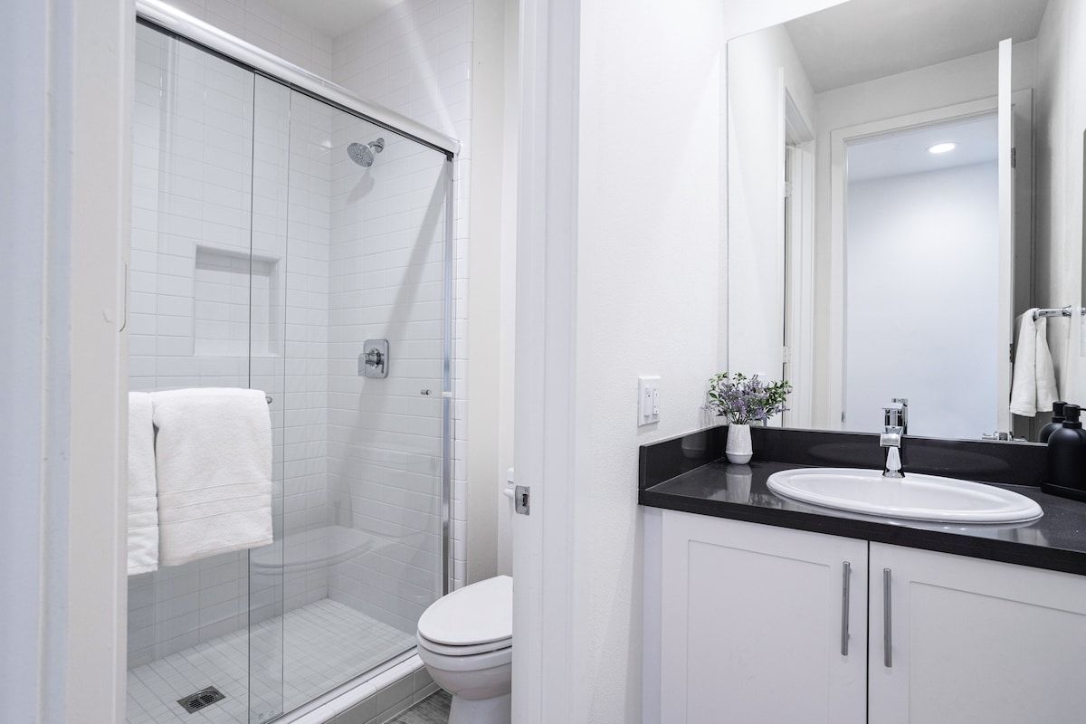 This first-floor bathroom features a separate shower area with a door, offering added privacy and comfort.