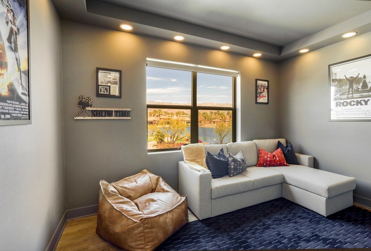 Enclosed bedroom with a cozy sofa bed, doubling as a home theater with a large screen and surround sound system. This room offers relaxing views of the desert, mountains, and lake.