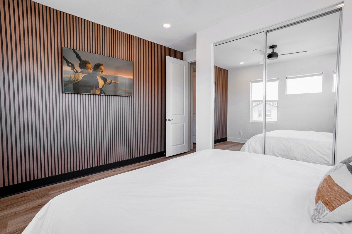 This comfortable and relaxing bedroom features a king-size bed and a 55" smart TV. The stylish room offers a plush mattress, and blackout blinds ensure a restful night's sleep.