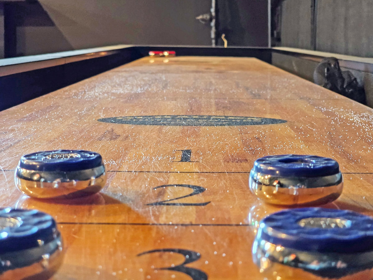 Endless entertainment awaits in this game room, complete with shuffleboard and your own private bar.