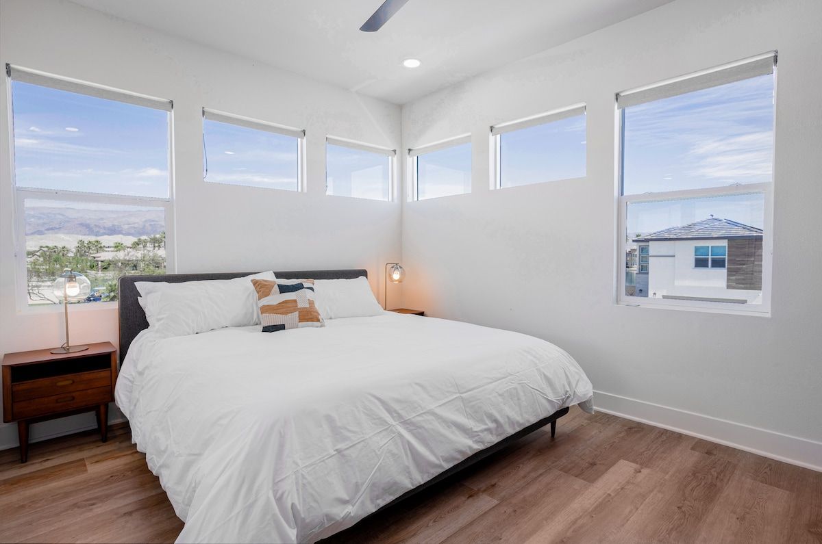 This 2nd-floor inviting bedroom is flooded with natural light and stunning lake and mountain views. Relax on the plush king bed with a 55" smart TV.