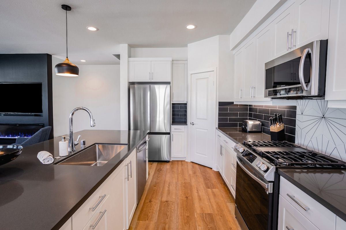 The modern kitchen, complete with top-of-the-line new appliances offers everything you need to create a delicious dinner or enjoy gatherings with friends and family