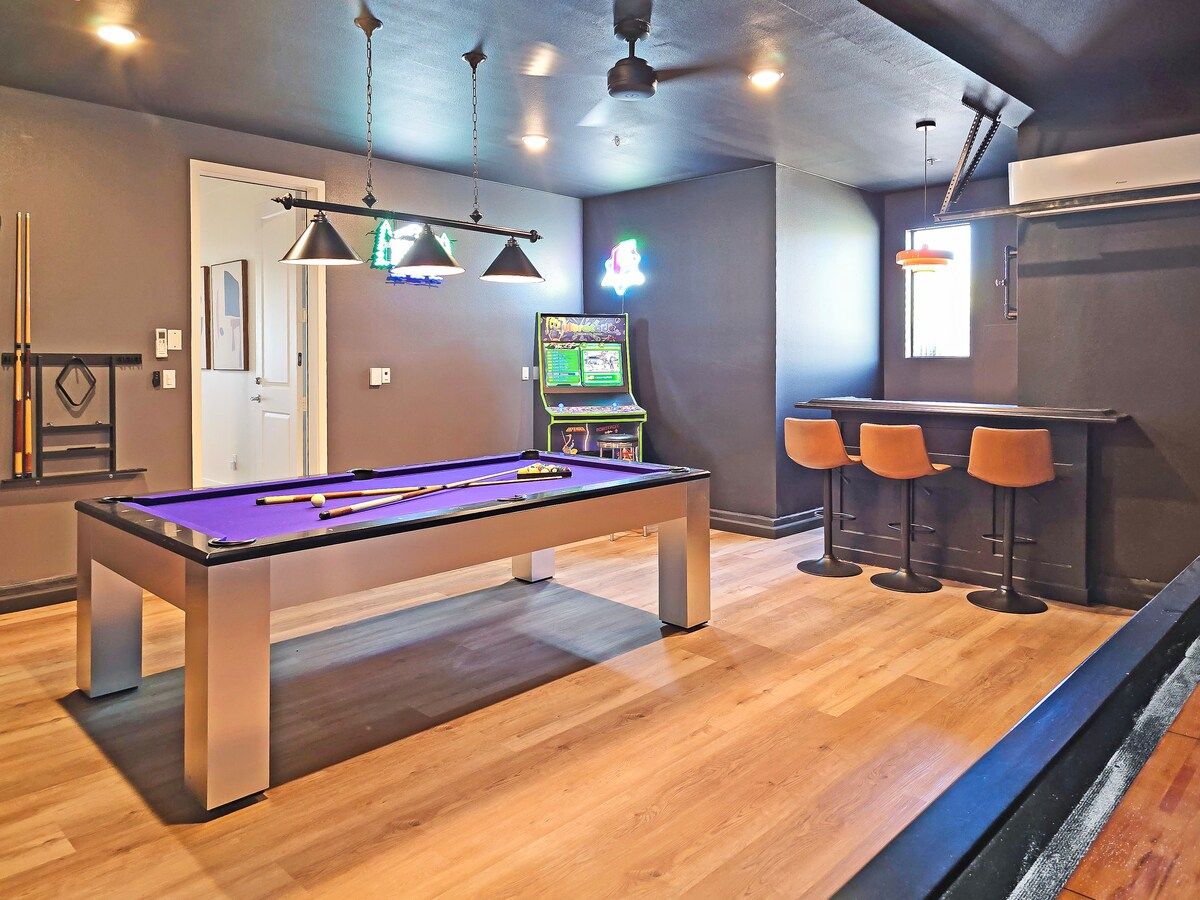 Step into the ultimate game room: neon lights, a sleek bar, and a multicade with 350 games. Challenge friends to pool or shuffleboard, enjoy the jukebox tunes, and gather around the 75" TV for fun. Perfect for kids and adults alike.