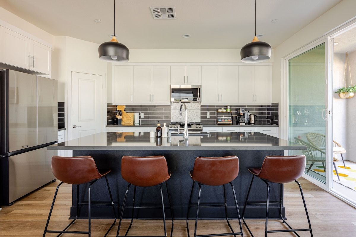 The kitchen features a breakfast bar, perfect for a quick meal, morning coffee, or casual dining