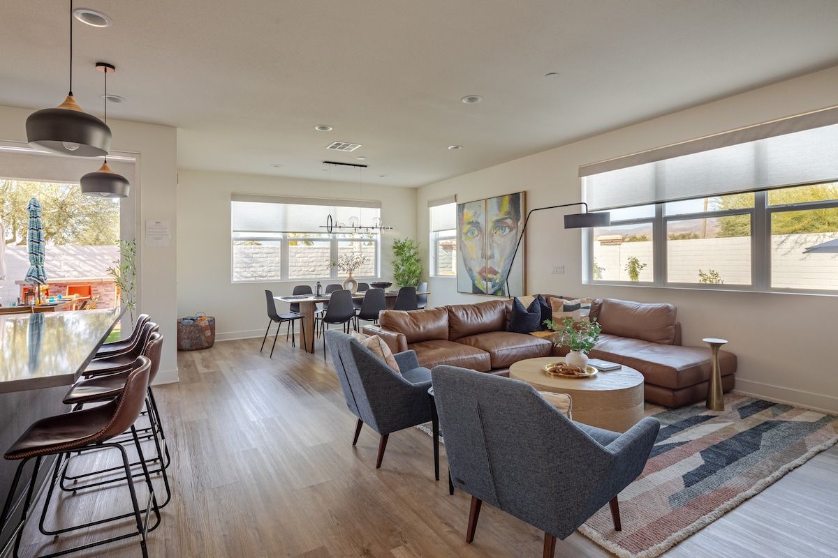 Step into a spacious, professionally designed living room featuring multiple seating areas and a plush L-shaped sofa for ultimate comfort. Enjoy fresh air, bright natural light, and stunning mountain views, creating a calming and inviting atmosphere.