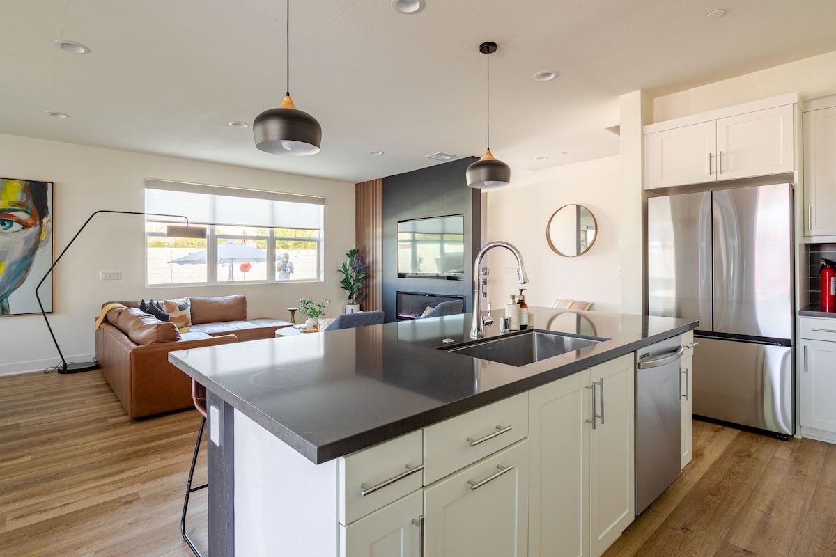 The living room features a cozy fireplace, built-in TV, and a very comfortable sofa, perfect for enjoying a movie, game night, or quality time together in a warm and inviting setting
