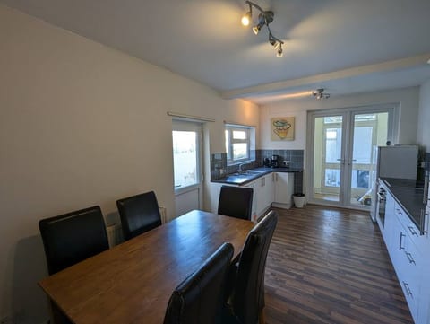 kitchen diner facing the backdoor and utility room