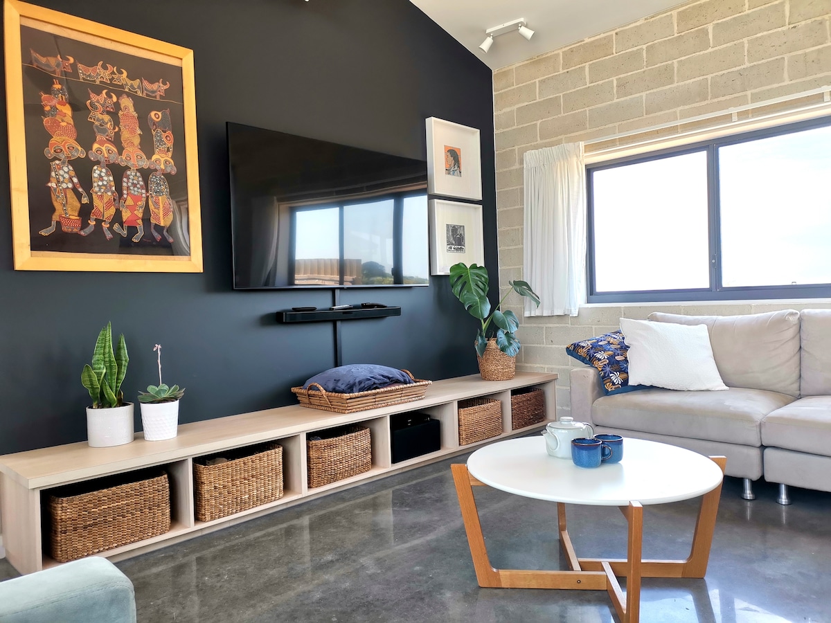 Media bench with baskets containing toys, puzzles, games and DVDs.