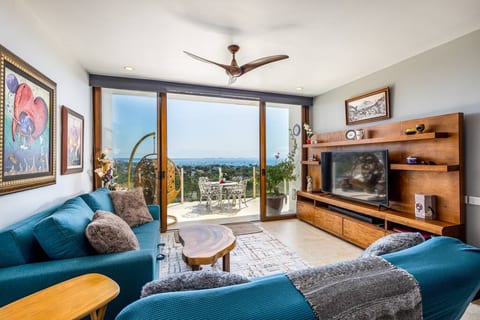 Relax in the spacious living room boasting a large TV and comfortable seating. Step onto the expansive terrace for stunning views overlooking Banderas Bay. Experience coastal bliss in style.