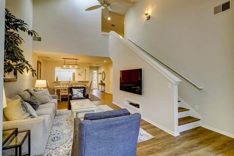 Living room and dining room view with staircase leading to upstairs bedroom