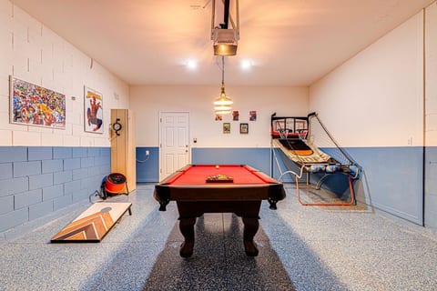 Marvel and DC Themed Games Room with 7.5ft Pool Table, Basketball Hoops, Dart Board and Corn Hole, for wholesome family fun.