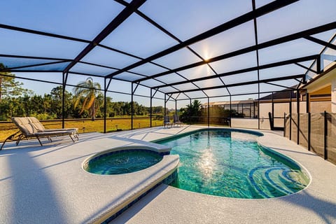 Extended pool and spa deck, south/south-west facing, with views onto conservation woodland and lake.