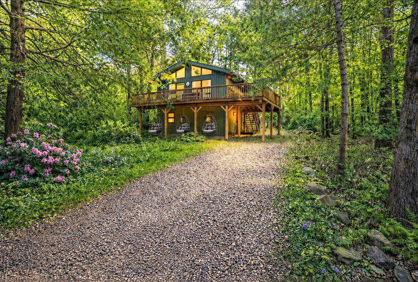 Tucked beneath a serene woodland canopy, this cozy cabin retreat invites you to unwind in style. Enjoy peaceful mornings or twilight evenings swaying in your private hanging chairs under the deck, surrounded by nature, quiet, and warm cabin charm.