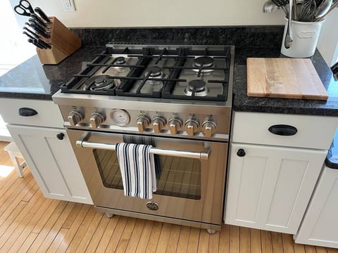 Bertazzoni gas range and electric oven installed in 2022 with superfast boil and pizza setting on the oven.