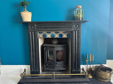 Cosy lounge with comfy sofa, Roku TV and wood burning stove