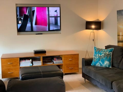 DOWNSTAIRS Lounge. Unwind and watch TV in the Lounge. Open plan and situated next to the kitchen, overlooking the outdoor deck.