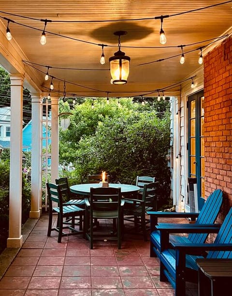 Dine al fresco on our spacious patio; perfect for enjoying morning coffee outdoors or evening conversations under the warm glow of our elegantly lit covered porch, a cozy spot for nightcaps