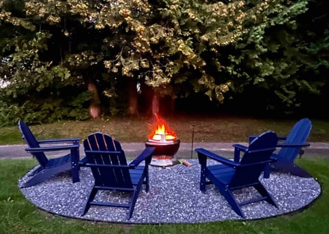 Fire pit and Adirondack chairs in the yard
