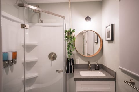 Private bathroom with glass enclosed shower.