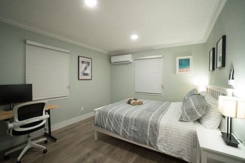 The smaller room with queen bed. This room also features a computer desk with a 27" monitor for hooking up to your laptop. Please remember to bring your own HDMI cable!