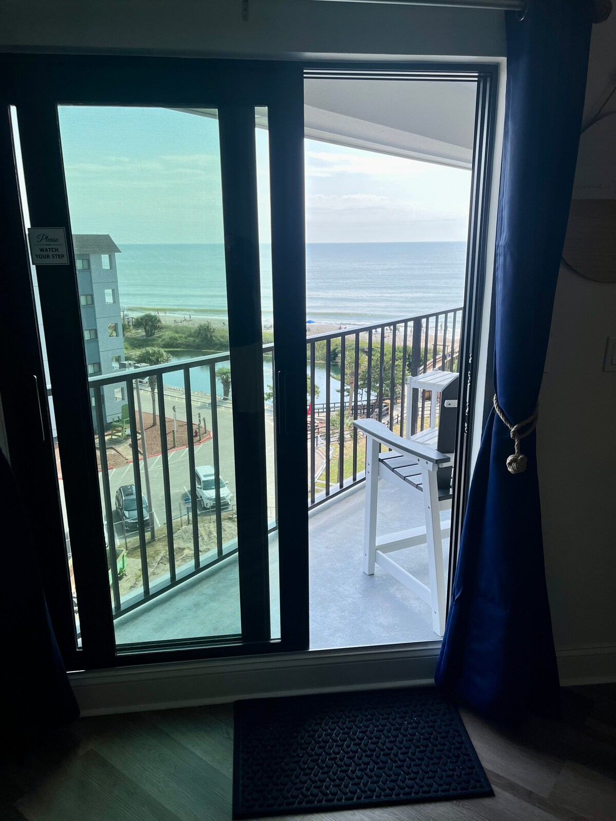 A closeup view of the beach from the living room, blending indoor relaxation with the beauty of the ocean.