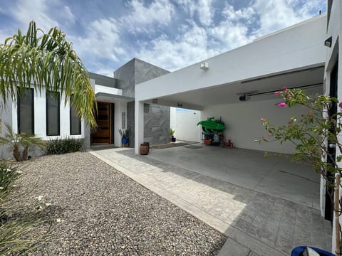 House's exterior, highlighting its clean design and tidy surroundings.