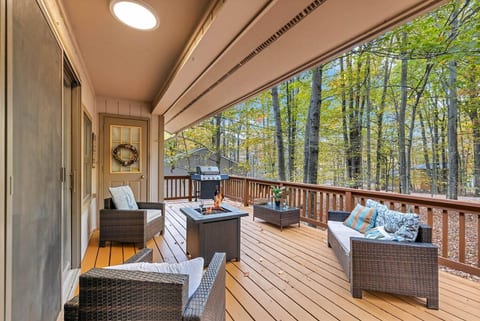 Enjoy the perfect summer retreat on this charming covered porch, complete with cozy wicker furniture and a sizzling grill.
