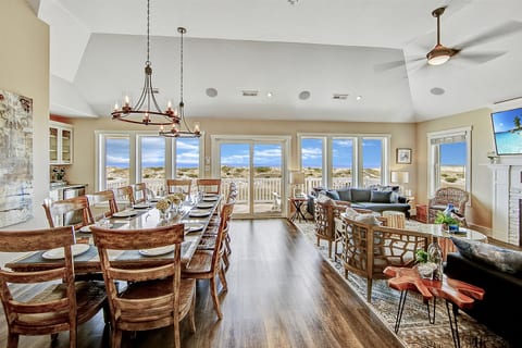 Welcome to the heart of the home! This great room features a spacious dining table, ample seating, and breathtaking panoramic ocean views that take your breath away.
