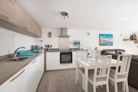 Fully equipped kitchen with fridge/freezer, washer/ dryer and dishwasher. Sea views from kitchen