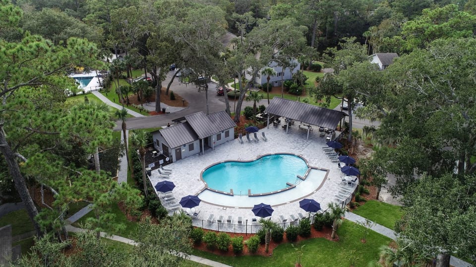 Pool #1 featuring large cabana with seating/dining area. Has zero depth area and bathrooms.