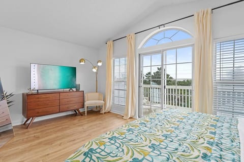 The primary bedroom provides ample storage for clothes, a smart TV and blackout curtains.