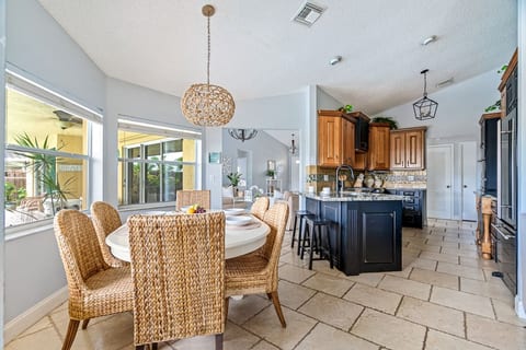 Eat in Kitchenette with seating for 6 and bay windows. Chef’s Kitchen with Jenn Air appliances. Fort Lauderdale Area Pool Home.