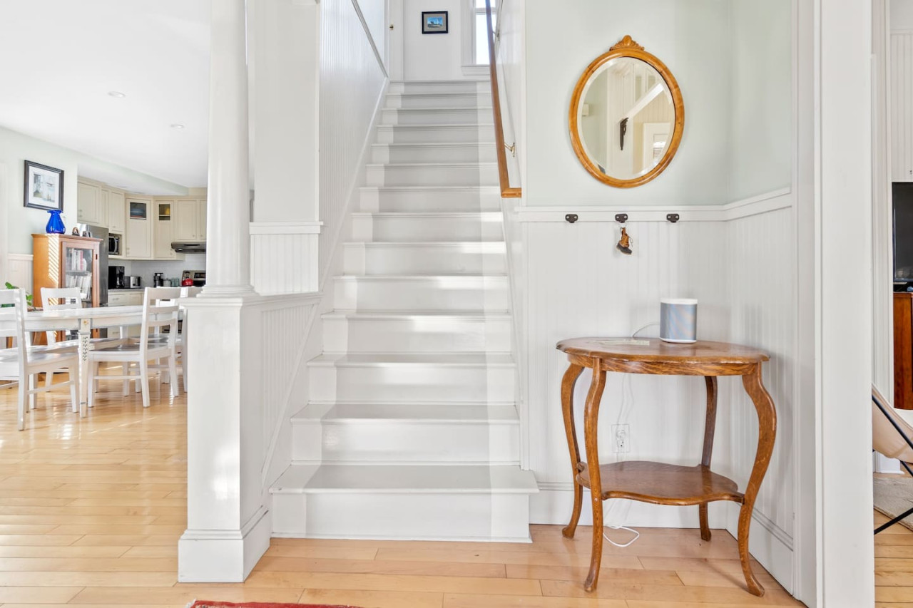 Welcome!! To the left is the eat-in kitchen, half bathroom, and a workspace. To the right is the living area and downstairs bedroom.