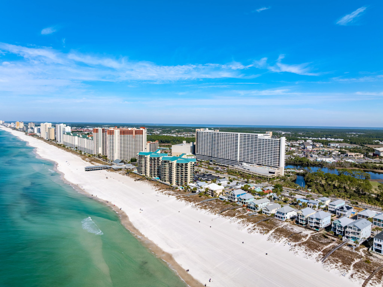 Stunning aerial view of Laketown Wharf Resort just steps from the sugar-white sands and emerald waters of Panama City Beach