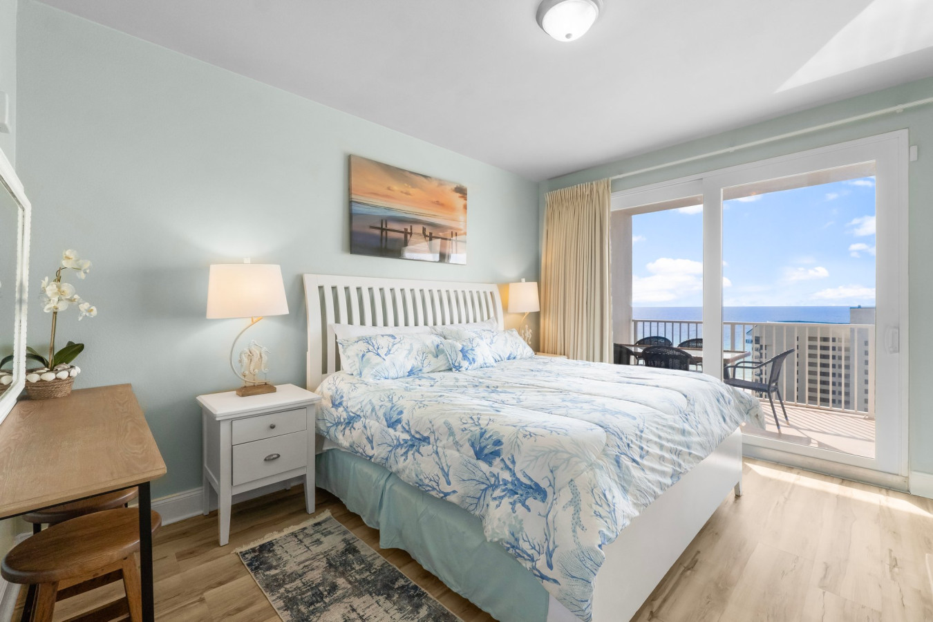 The master bedroom features a king-sized bed, ocean views, and direct access to the private balcony.