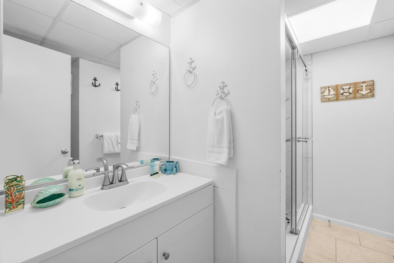 modern bathroom features a sleek walk-in shower with marble-style tile, a rainfall showerhead, and built-in shelving for a spa-like experience.