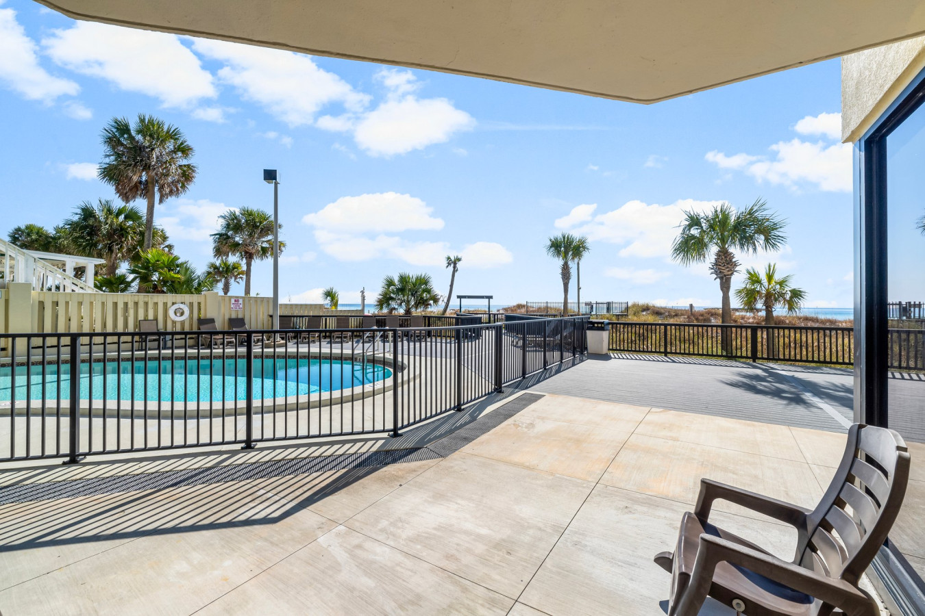 Patio offers direct access to the pool and breathtaking views of the beach, perfect for relaxing under the Florida sun.