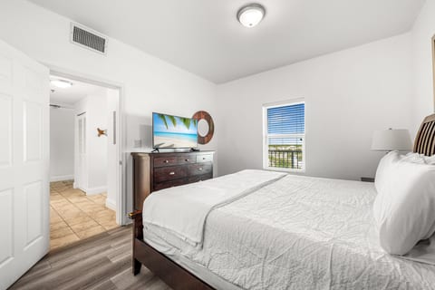 This spacious second bedroom features a king-size bed and modern decor for a comfortable stay