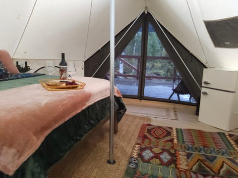 Relax in your bell tent while enjoying the peaceful outdoor views.