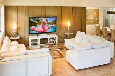 Kick back in the sleek, sun-filled living room—perfect for movies, games, and effortless relaxation.
