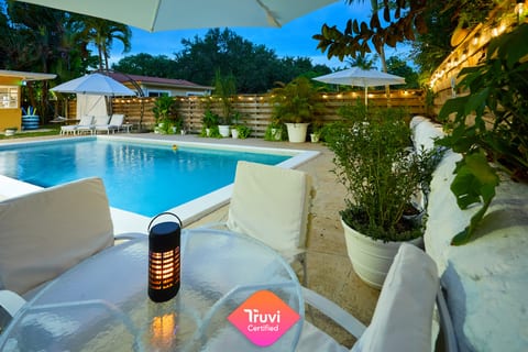 Your evening oasis—string lights, warm water, and Miami nights that feel like magic.