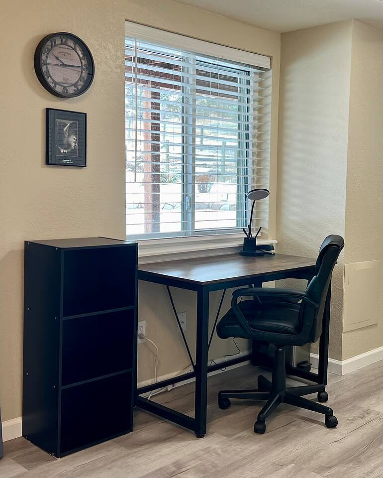 A work station with desk and bookcase for storage with secure high speed WiFi. A great view of the backyard and seasonal waterfall.
