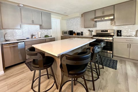 A spacious space to prepare meals with a fully equipped kitchen. A large island is the prefect gathering spot with comfortable bar stools.