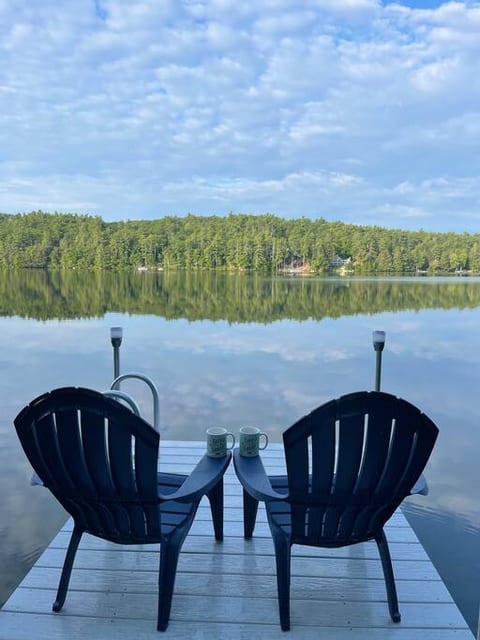 Coffee on the dock and crystal clear reflection on the glassy lake