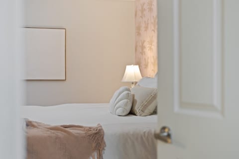 Master bedroom with new king bed, smart TV, private attached bathroom, ceiling fan and double closets.